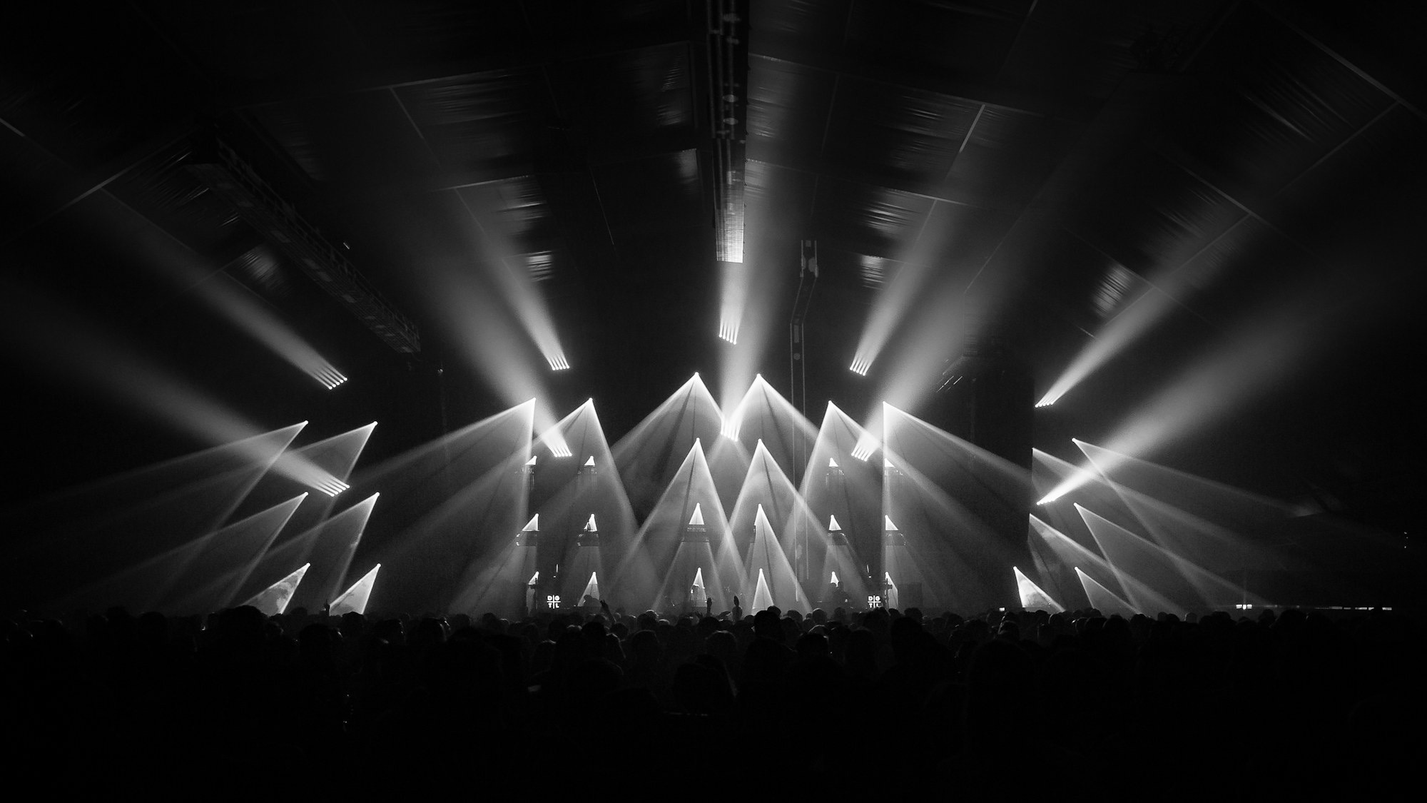 Stage lights sweeping over the audience at a concert